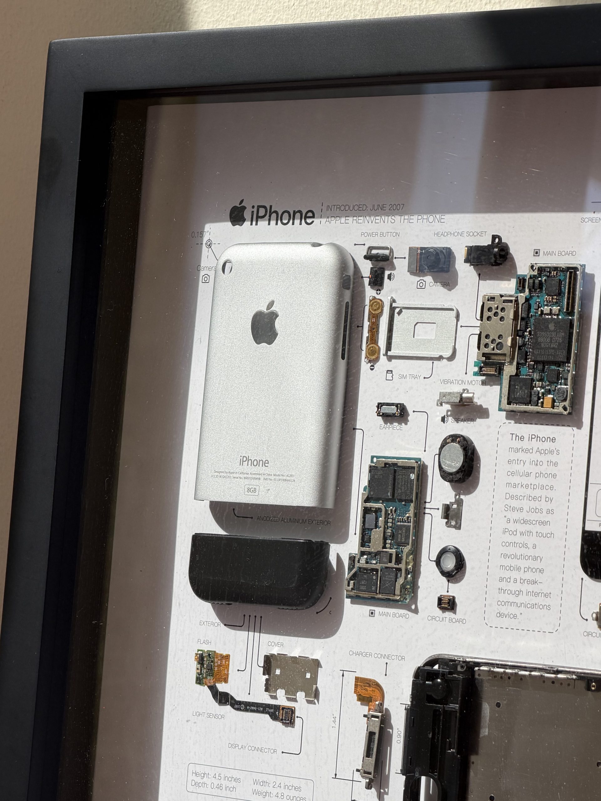Picture of the original iPhone in a frame with the iPhone 17 Pro Max at 5X telephoto